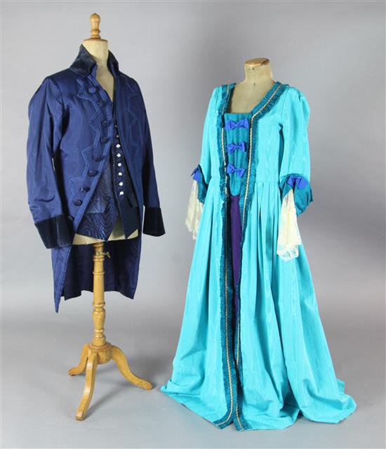 Cosi Fan Tutte: A rail with a blue and green, turquoise and green, gold and orange dresses, a blue velvet trimmed